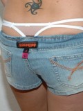 Kalees white thong is peeking out of her little jean shorts