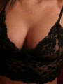 Alyssa Roxis huge tits are barely covered by her black lace top