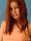 Kori nipping in her peach top